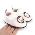 Detail of white baby walking shoes featuring a cartoon lion and Velcro strap - Insole Length 11cm / White
