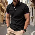 Detail view of a black men's polo shirt featuring striped collar and button placket. - S / Tops / Black
