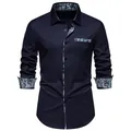 Detail view of a men's navy long sleeve shirt featuring stylish paisley patterned accents. - Navy Blue