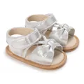 Detailed view of silver baby girl sandals featuring a cute bow and soft non-slip sole - Silver