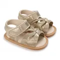Close-up view of golden glitter baby girl sandals featuring a bow knot and soft non-slip sole - Gold