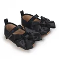 Zapatos de suela blanda para bebé niña con un lazo grande de satén negro elegante - Negro