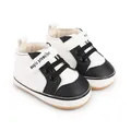 Detailed view of black and white baby prewalker shoes featuring magic prewalker text - 11cm / White