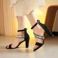 Elegant black chunky heel sandals with sparkling rhinestone straps and buckle closure. - Black