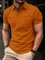 Detailopname van een oranje heren polo met korte mouwen en een unieke zak op de arm - S / Tops / Oranjerood