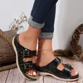 Detailed view of black crocodile-textured double-buckle wedge sandals on a model - Black