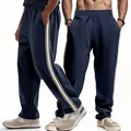 Macro view of navy blue men's relaxed fit jogger pants featuring white side stripes - S / Bottoms / Navy Blue