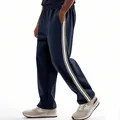Side view detail of navy blue joggers with contrast white stripes and elastic waist. - S / Bottoms / Navy Blue