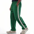 Side view of men's green track pants featuring classic white and black side stripes - S / Bottoms / Grass Green