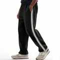 Side detail view of men's loose black jogger pants with sporty white side stripes - S / Bottoms / Black