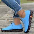 Detailed side view of light blue handmade flat loafers with soft rubber soles and stitching - Sky Blue