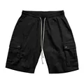 Detailed view of men's black slub linen cargo shorts with drawstring and side pockets - S / Bottoms / Black