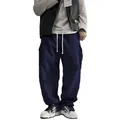 Detailed view of men's retro corduroy cargo pants with a loose straight leg fit. - S / Bottoms / Navy Blue