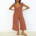 Detailed view of women's terracotta wide-leg jumpsuit with U-neck and tie-up shoulder straps - Coral