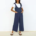 Detail view of a navy blue wide-leg jumpsuit with front pockets and tie-shoulder straps. - Navy Blue
