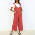 Detailed view of terracotta wide-leg jumpsuit with shoulder ties and patch pockets - Watermelon red