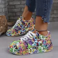 Close-up of colorful graffiti print sneakers with thick white platform soles for women. - 38 / Colorful