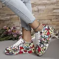 Detailed view of colorful graffiti patterns on trendy platform sneakers for women - 36 / Red