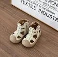 Close-up of toddler cream Roman sandals showing side zipper and soft textured upper. - Beige