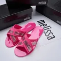 Stylish pink Melissa jelly slides featuring cross straps with silver logo lettering detail - Rose Red