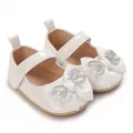 Close-up detail of white patent leather baby princess shoes with sparkling rhinestone bow - Insole Length 11cm / White