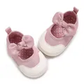 Close-up of pink baby soft sole walker shoes featuring a large bow and polka dot lining - Insole Length 11cm / Pink