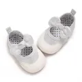 Detailed top-down view of silver baby walking shoes with decorative bows and polka dot lining - Silver