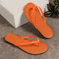 Vibrant orange women's thong flip-flops with a sleek minimalist design and flat sole - Orange