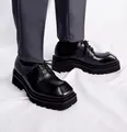 Detail view of men's black leather square-toe Derby shoes with thick platform soles. - 38 / Black