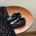 Close-up of black toddler Mary Jane shoes with brogue details and buckle strap. - Size 28 (Insole 17.5cm Fits Foot 16.5-17cm) / Black