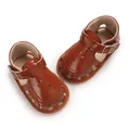 Close-up of brown baby girl walking sandals with floral hollow-out design and soft sole - Brown