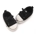 Close-up detail of classic black and white canvas baby sneakers for pre-walking infants - Insole Length 11cm / Black