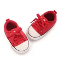 Top down view of red infant canvas walking shoes with white toes and soft soles - Insole Length 11cm / Red
