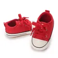 Detail view of stylish red infant canvas sneakers with soft white soles for walking - Insole Length 11cm / Red