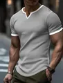 Detailed view of a men's grey textured knit t-shirt with a stylish white V-notch collar. - Gray