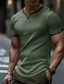 Detailed view of men's olive green waffle knit T-shirt featuring a V-neck with black trim - Green