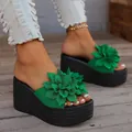 Green platform wedge sandals featuring a large 3D floral ornament and black textured sole - 34 / Green