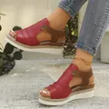 Detailed close-up view of red and brown wedge sandals with espadrille platform soles - Red