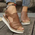 Close-up of brown platform wedge sandals with braided jute sole and buckle strap - Brown