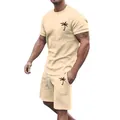 Detail of beige men's summer set with black palm tree embroidery on chest and shorts. - Khaki