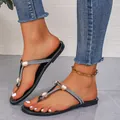 Elegant black flat T-strap sandals with sparkling rhinestones for summer beach wear. - Black