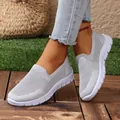 Casual grey breathable mesh knit slip-on sneakers for women shown in an outdoor lifestyle setting - 36 / Gray