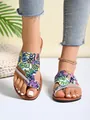 Detailed view of women's flat sandals featuring colorful graffiti print and rhinestone strap - 36 / Multicolor