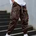 Detail view of men's brown multi-pocket cargo pants with tapered elastic cuffs - Dark Brown