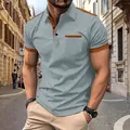 Detail view of men's casual polo shirt with grey and orange color block design - S / Tops / Light Gray