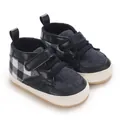 Close-up of navy blue plaid infant walking shoes with soft anti-slip soles and straps - Dark Blue