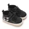 Detailed close-up of anti-slip baby walking shoes in black and white checkered design - Black