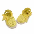 Close-up detail of yellow lace baby sandals featuring elegant ribbon bows for newborns - Insole Length 11cm / Yellow