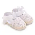Detailed view of white crocheted lace baby sandals with soft elegant ribbon bows. - Insole Length 11cm / White