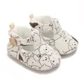 Close-up of white baby walker shoes with black and white cartoon bear patterns - White